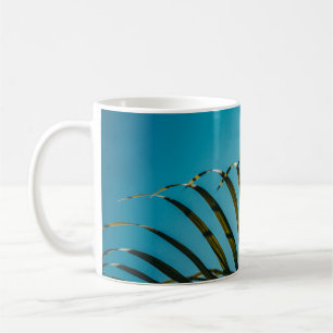 Green palm plant under blue sky in the morning coffee mug