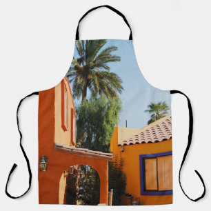 Green palm tree beside brown concrete building in  apron