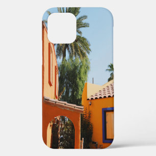 Green palm tree beside brown concrete building in iPhone 12 case
