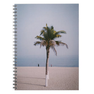 Green palm tree on seashore notebook