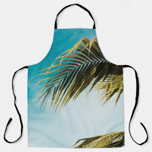 Green palm tree under blue sky apron