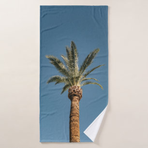 Green palm tree under blue sky in the morning bath towel