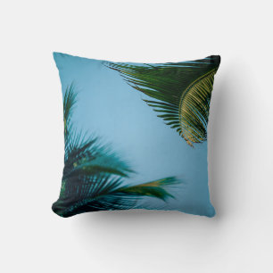 Green palm tree under blue sky in the morning cushion