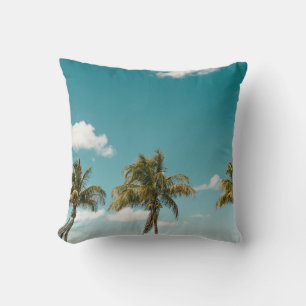 Green palm tree under blue sky in the morning cushion
