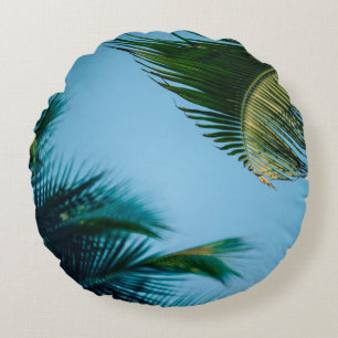 Green palm tree under blue sky in the morning round cushion