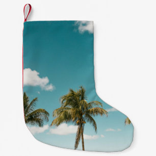 Green palm tree under blue sky in the morning small christmas stocking