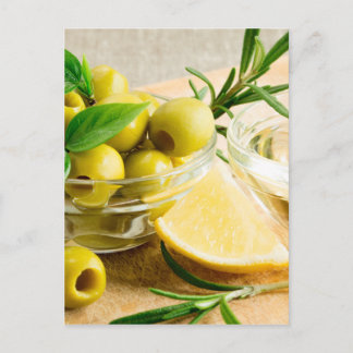Green pitted olives decorated with herbs postcard