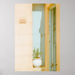 GREEN PLANT WITH CERAMIC VASE BESIDE WHITE WOODEN POSTER