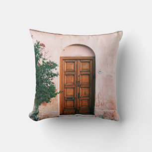 GREEN PLANTS BESIDE BROWN WOODEN DOOR CUSHION