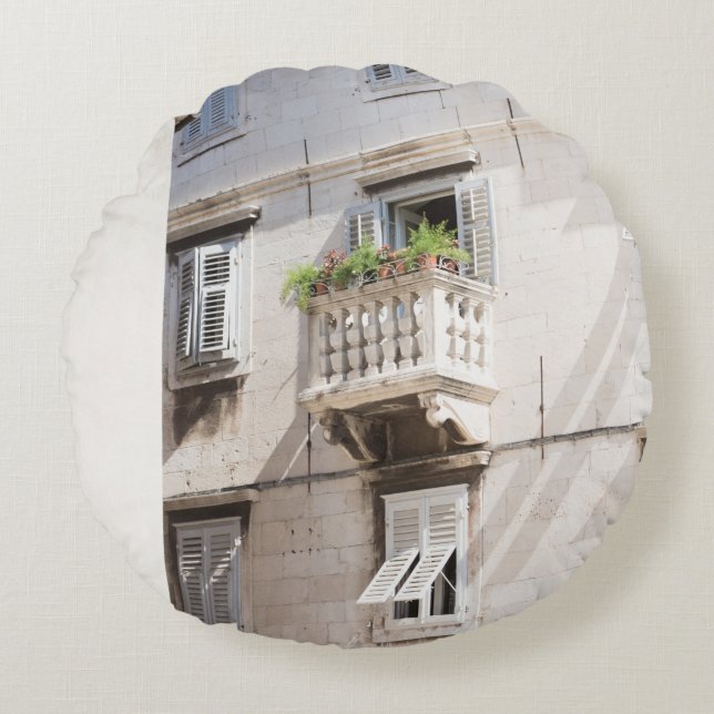 GREEN POTTED PLANT ON BROWN CONCRETE HOUSE BALCONY ROUND CUSHION (Front)