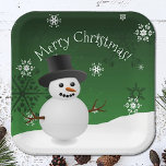 Green Snowman Winter Scenery Christmas Paper Plate<br><div class="desc">Brighten your holiday party supplies with this Green Snowman Winter Scenery Paper Plates, perfect for your Christmas party supply needs. These charming plates feature a winter scene with a snowman and top hat, accented by white snowflakes and falling snow. The holiday typography displaying "Merry Christmas" adds a joyful touch to...</div>