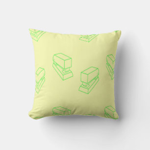 Green stapler on yellow cushion