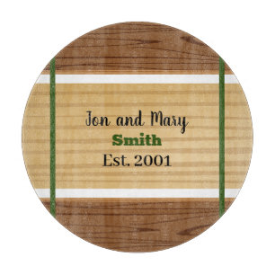 Green striped and wood-look cutting board .
