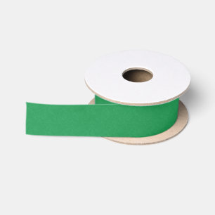 Green textured surface with swirling pattern satin ribbon