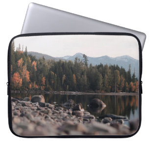 GREEN TREES REFLECTION ON BODY OF WATER DURING DAY LAPTOP SLEEVE