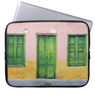 GREEN WOODEN DOOR ON WHITE CONCRETE WALL LAPTOP SLEEVE