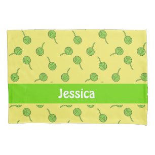 Green wool rolls on yellow pillowcase
