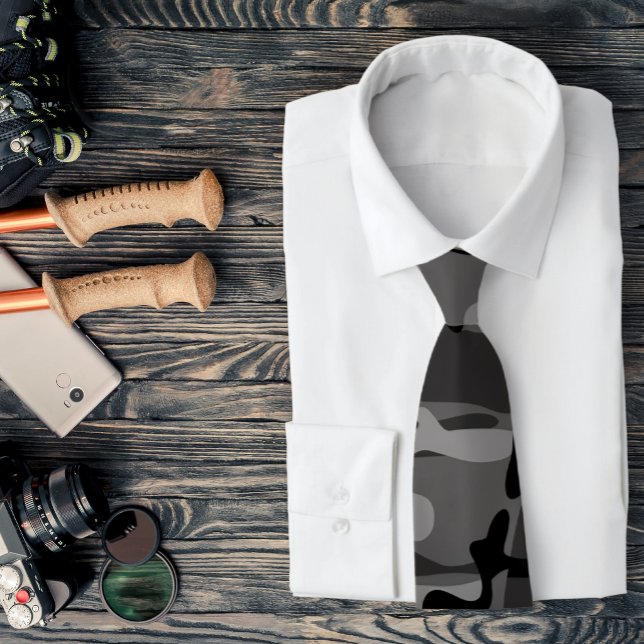 Grey and Black Camouflage Necktie (A gray camo necktie is featured on a shirt and a assemblage of outdoors related accessories.)