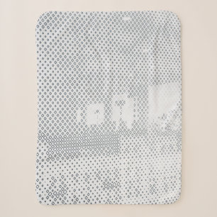 Grey and white chequered textile sherpa blanket