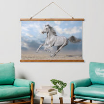 Grey Arabian Horse Gallops Through Sandy Landscape