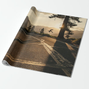 Grey asphalt road near mountain in the morning wrapping paper