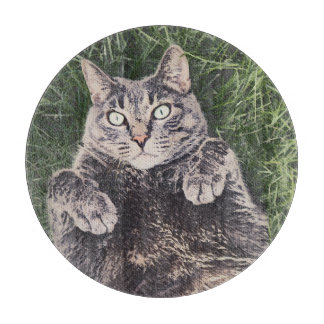 grey cat lying in the grass digital art cutting board