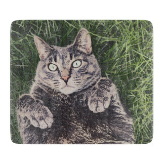 grey cat lying in the grass digital art cutting board