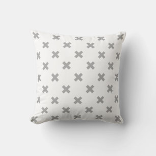 Grey cross stitches on white cushion