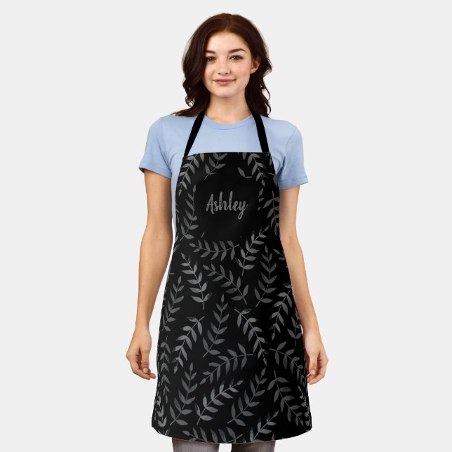Grey leaves pattern on black custom name apron (Worn)