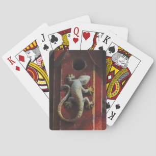 grey lizard on worn wood playing cards