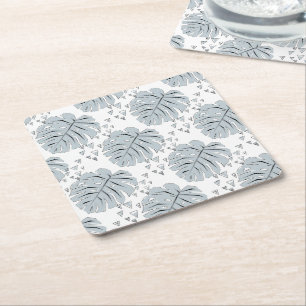 Grey monstera leaves on white square paper coaster