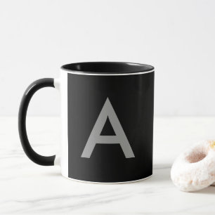 Grey on black, initials as letter. mug