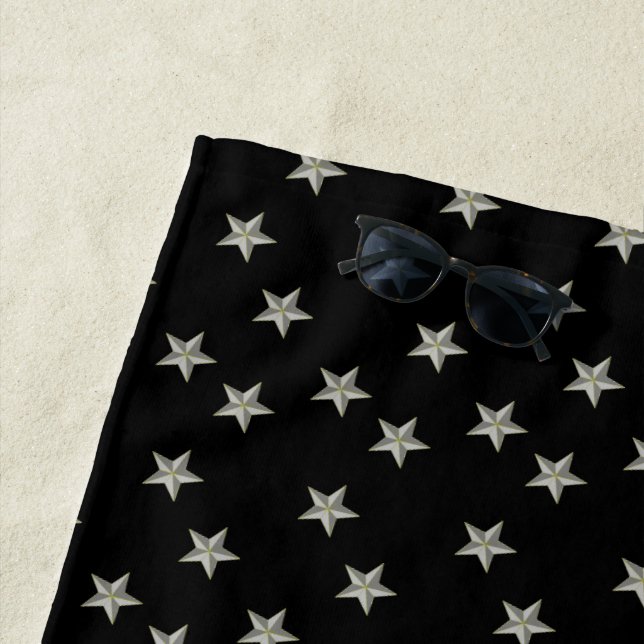 Grey stars pattern on black beach towel (In Situ)