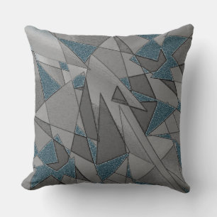 Grey triangular cutouts on blue background, rough cushion
