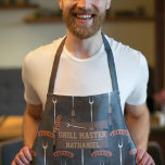 Grill Master Black Sausage Grilling Fork Name Apron<br><div class="desc">This cool and modern pattern is perfect for the grilling master. It features a hand-drawn brown, tan, silver, black, and dark gold sausage with a grill fork cartoon illustration pattern on top of a black abstract pattern. This design also features the phrase, "Grill Master, " with a monogram name. It's...</div>