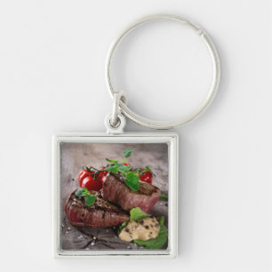 Grilled bbq steaks with fresh herbs and tomatoes key ring