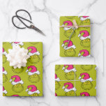 Grinch in Pink Santa Hat Wrapping Paper Sheet<br><div class="desc">This fantastic, bold illustration is a close-up portrait of the Grinch in full mischievous mode! He has his signature sly grin and bright yellow eyes, but his look is updated with a large, fluffy Santa hat in a fun, unexpected pink/fuchsia color instead of the traditional red. This graphic is perfect...</div>