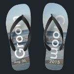 Groom Ocean Waves Beach Sand Flip Flops<br><div class="desc">Pretty Blue Sky with Light Fluffy White Clouds, Blue Sea, Crashing Ocean Waves and Beach Sand. Unisex Flip Flops with Groom and Date of Marriage written in a white colour text. PERSONALIZE with your Wedding DATE (or delete text). The wedding date is written in the sand. Shown with Wide Black...</div>