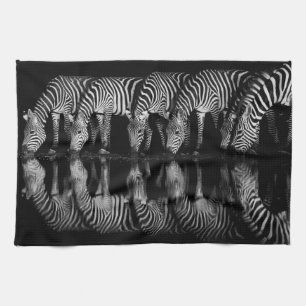 Group of Plains Zebra Drink Together at Night Tea Towel