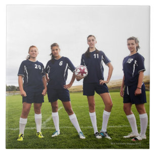 group portait of teen girl soccer players tile