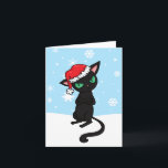 Grumpy Black Cat wearing Santa Hat Holiday Card<br><div class="desc">Featuring MuffinPuffARTS! Newest cartoon character Elliot,  a rather grumpy black cat. He wears a jolly looking father Christmas Santa hat,  and with his arms folded and eyes glaring on a blue snow flaked filled background. Illustrations by Jojo Kneebone - Aka MuffinPuffART!</div>