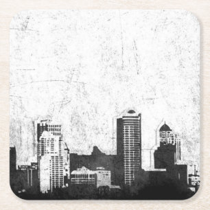 Grungy city background in black and white square paper coaster