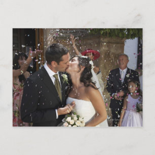 Guests throwing confetti over kissing bride and postcard