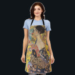 Gustav Klimt Lady with a Fan  Art Nouveau Apron<br><div class="desc">Gustav Klimt's "Lady with a Fan" is a mesmerising portrait that captures the essence of the Jugendstil and Art Nouveau movements. The painting features a regal woman, her gaze direct and confident, holding an ornate fan in her hand. She is adorned in a dress that is a symphony of rich...</div>