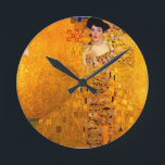 Gustav Klimt Portrait of Adele Bloch Bauer Round Clock<br><div class="desc">Clock featuring Gustav Klimt’s oil painting Portrait of Adele Bloch Bauer I (1907). A beautiful woman wears a golden and geometric dress in front of a gold background. A great gift for fans of Art Nouveau and Austrian art.</div>