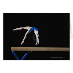 Gymnast (9-10) flipping on balance beam, side