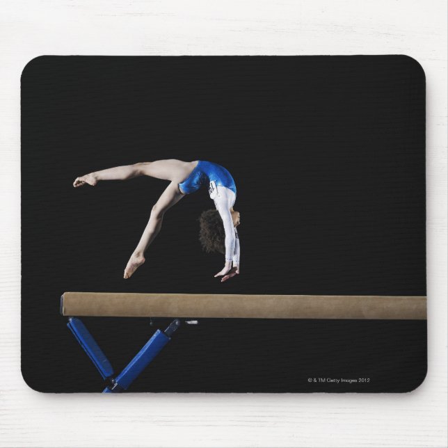 Gymnast (9-10) flipping on balance beam, side mouse mat (Front)