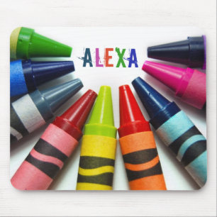 half circle of crayons on white mouse mat