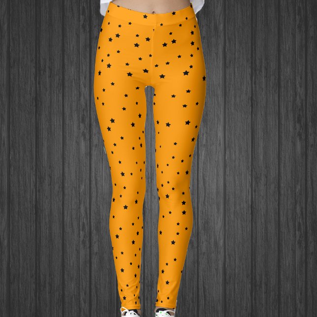 Halloween Colours black stars on bright Orange Leggings (Halloween colours of black stars on bright orange celestial womans leggings.)
