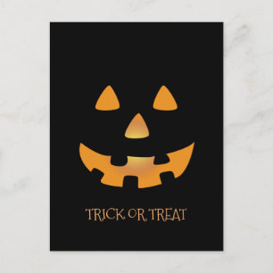 Halloween pumpkin face on black background postcard